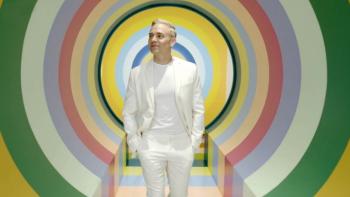 It's OK to Ask Questions: Matthew Rodrigues is shown in the center of colorful rings 