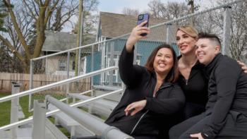 It's OK to Ask Questions: Three friends take a selfie together, holding the camera high