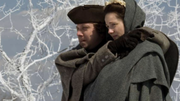 John Adams screenshot 1: John hugging Abigail Adams while walking in the snow. 