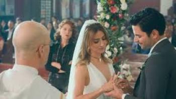 Just Alice TV show screenshot #1: A dark-haired man marries a brunette woman. He puts a ring on her finger.