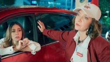 Just Alice TV show screenshot #2: a young woman is in the driver's seat of a car as another woman stands outside with her hand on the car.
