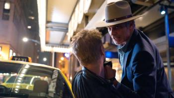Justified: City Primeval: Raylan looms over another man, looking as if he's going to punch him or just has. 