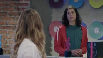 Kally's Mashup TV show screenshot 1: Blonde woman with her back to the camera. Facing her is a young man with dark, curly hair.
