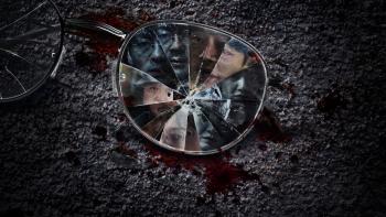 Karma TV show screenshot: A shattered pair of glasses lays on the stone with many people in the lense.
