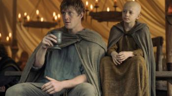 A Knight of the Seven Kingdoms TV show screenshot 1: Dunk and Egg sit together in an indoor shot, with candles behind them; both look serious 