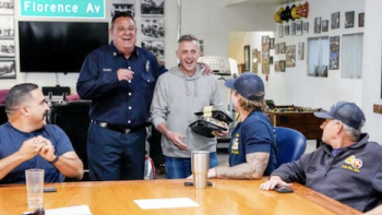 LA Fire & Rescue TV show screenshot 3: Firefighters socializing around table at station. 