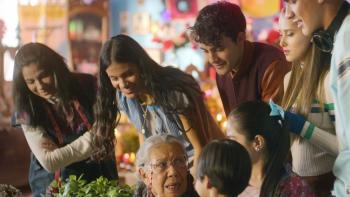 La flor mas bella/The Most Beautiful Flower TV show screenshot 3: a group of smiling Latino teens leans over an older woman and child. 