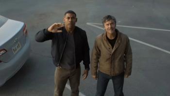 Lanterns: John and Hal are seen from above, looking up from a parking lot at something that's dismaying; John's hand is upraised defensively