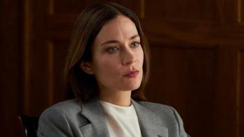 Law & Order Toronto: Criminal Intent: Kathleen Munroe sits, looking serious. 