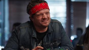 Let's Get Physical Series: A man in a denim jacket with a bandanna around his forehead squints into the camera. 
