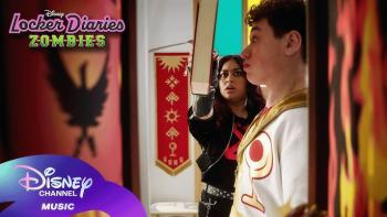 Locker Diaries ZOMBIES TV show screenhot 3: Vera holds a book in front of Ray's face, protecting him from being hit by a fork which stabs the book.