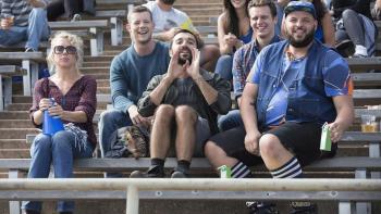 Looking TV Show: A group of friends, four men and one woman, sit in a crowd cheering from the bleachers