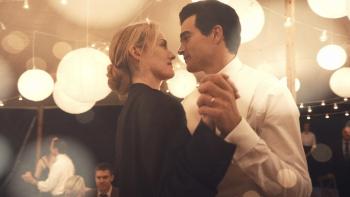 Love Story TV show screenshot 3: Sarah Pidgeon and Paul Anthony Kelly hold hands while dancing. Pidgeon wears black, while Kelly wears white.