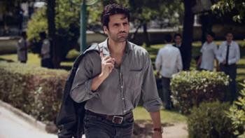 Love 101 screenshot 3: Kemal walks into the school, wearing a grey button-down shirt. He has a jacket slung over his shoulder