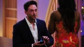 Love is Blind: UK screenshot: A white man kneels before a black woman proposing