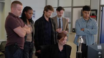 Maigret TV show screenshot 2: Maigret's team looks at a computer screen