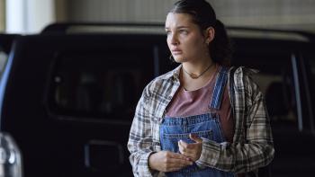 Man on Fire TV show screenshot 2: Billie Boulet wears denim overalls, a red shirt, and a striped buttoned shirt. 