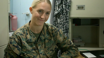 Marines TV show screenshot 1: Lt. Samantha Miller sits in fatigues.
