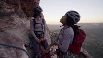 Memphis to the Mountain TV show screenshot #1: two people stand on the side of mountain in climbing gear