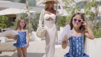 Million Dollar Nannies TV show screenshot 3: Nicola Wills in white dress and hat with two girls in blue swimsuits and sunglasses.