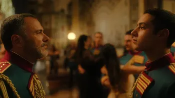 Minerva Academy TV show screenshot 4: Achille and Salvo stare at each other in ornate military uniforms in a fancy ballroom.