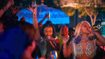 Miseducation TV show screenshot 2: Buntu Petse as Mbali, drinks straight from a bottle while dancing at a party. She wears a holographic top.