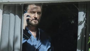 Missing You TV show screenshot 3: Detective Ellis Stagger on his phone in the shadows