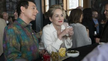 Mosaic Series: A man and a woman are sitting together at a bar, looking at something behind the bar; the woman is smiling and the man looks bemused. 