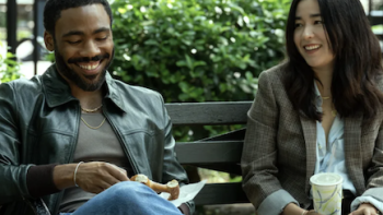 Mr. & Mrs. Smith TV show screenshot 1: Danny Glover and Maya Erskine as John and Jane Smith talking on bench.