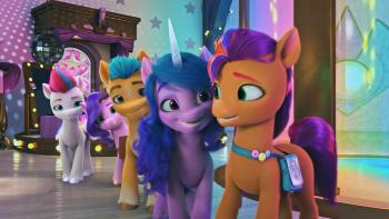 Four of Sunny's pony friends smile at her in front of a stage with a disco ball.