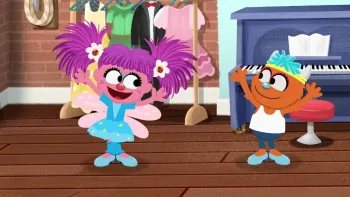 My Sesame Street Friends My Abby TV: Abby and Rudy wear dance costume and dance together in a studio with a piano in the background.