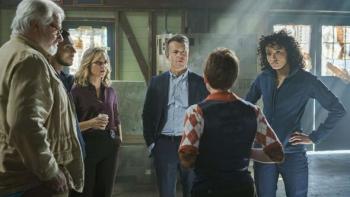 NCIS Sydney: A group of six people stand in a circle, five of which eye the youngest member. 