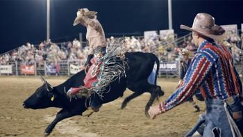 Not Her First Rodeo TV show screenshot 1: Female bull rider Jorden Halverson comes out of the rodeo gate atop a black bull