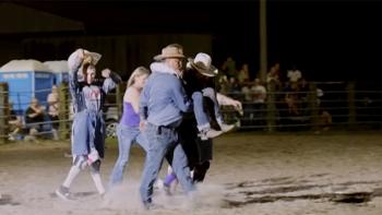 Not Her First Rodeo TV show screenshot 2: A female bull rider is carried out of the arena after a bull stomps on her ankle