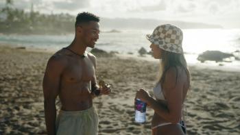 Oahu Shores TV show screenshot: A Hawaiian man and women in bathing suits stand on the beach talking to each other