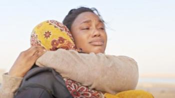 Oloture: The Journey TV show screenshot: Two Nigerian woman hug in an emotional embrace.