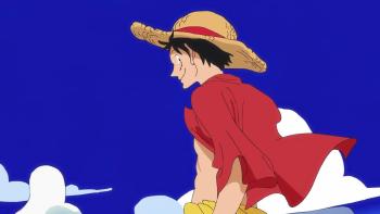 One Piece Fan Letter: An upwards shot of Luffy D. Monkey looking out to sea. The sky is bright and blue behind him. Wind ruffles his clothes.