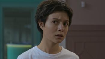 Open Your Eyes TV show screenshot 1: Julia, a teen girl with short brown hair, looks to the side with a guarded expression. 