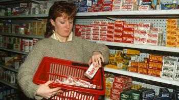 Painkiller: The Tylenol Murders TV show screenshot: A woman with an 80s haircut is shown putting Tylenol into her shopping basket.