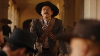 Pancho Villa: The Centaur of the North screenshot 1: Pancho Villa stands and leans on table. 