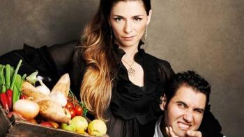 The Pasta Queen TV show screenshot 1: A woman hold veggies in one hand, and has a man in a loose headlock in the other.
