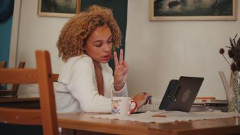 Isla stares forlornly into her laptop