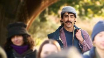 People Like Me TV Show screenshot 3: Vongirdner stands in a park. He wears a light grey beanie, dark blue vest.