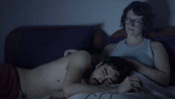 People Like Me TV Show screenshot 1: Devon Vongirdner and Ava Gordy lay in bed. Vongirdner has his head in Gordy’s lap as she pats his head.