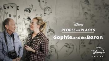 Pic from the People & Places ep Sophie and the Baron shows the artist duo smiling at each other in front of a sketchy black and white mural