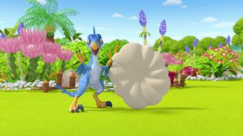 Pinkfong Little Dino School TV show screenshot 2: Vella, the blue velociraptor, holds a big white fossil in front of colorful flower garden.