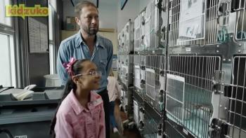 Reading Rainbow TV show screenshot 3: Actor Ebon Moss-Bachrach accompanies a young girl with glasses as they visit an animal shelter in NYC.