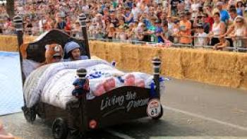 Red Bull Soapbox Race: A bed race car drives down a track