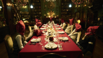 Re: Mind TV show screenshot 3: 11 girls with red bags on their heads sit at a dining table in room full of antique decor