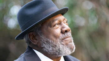 Ripple TV show screenshot 3: Walter wears a black hat and looks up at the sky.